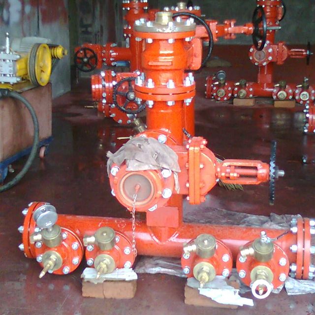 Orange gate valves assembled on a pipe manifold